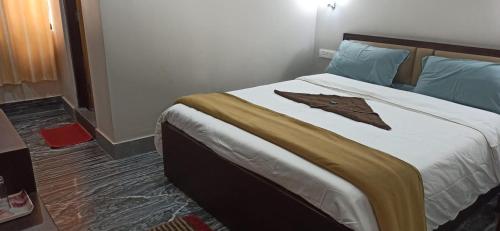 a hotel room with a bed with a robe on it at Hotel Sonar Tori in Gangtok