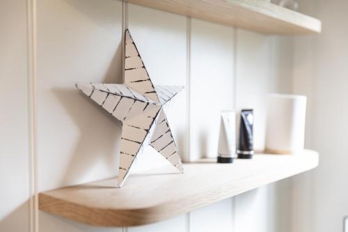 a wooden star on a shelf in a room at Whitbourne farm in Corsley