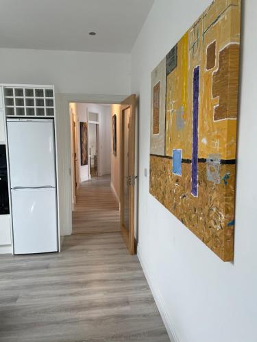 a hallway with a painting on the wall at Lough Key Luxury Riverfront Apartment in Cootehall