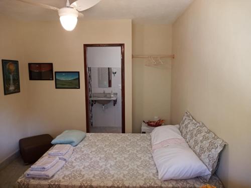 a bedroom with a bed with a sink and a mirror at Eco Parque Cachoeira Moxafongo in Santa Leopoldina