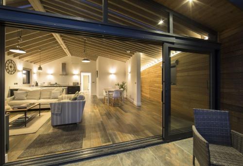 a living room and dining room with sliding glass doors at Dorset Eco Retreats in Ansty