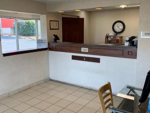 a waiting room with a counter and a clock on the wall at Days Inn by Wyndham Harrisonburg in Harrisonburg