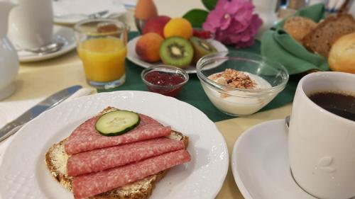 a table with a plate of food and a cup of coffee at Landhaus Kyritz in Kyritz