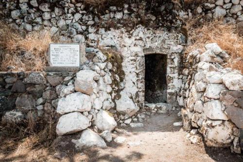 an old stone building with a plaque on it at Lava House in Mandrakion