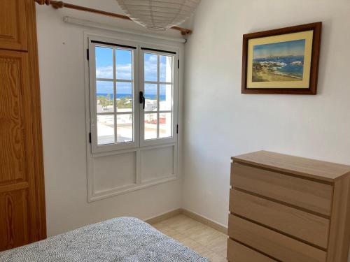 a bedroom with a window and a dresser at Aires de Mar in Playa Honda