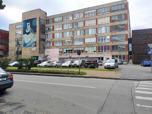 a parking lot with cars parked in front of a building at Like a home Linda Apartment in Narva