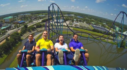 a group of people sitting on a roller coaster at Bposhtels Orlando Florida Mall in Orlando