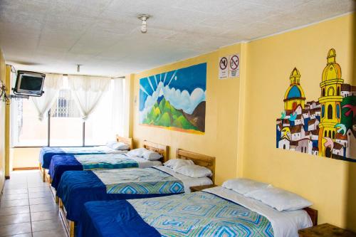 A bed or beds in a room at La Posada Del Viajero