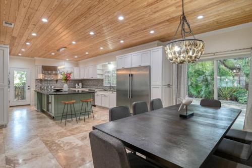 a kitchen and dining room with a large dining table at Golden Mile Beach Retreat in St. Augustine