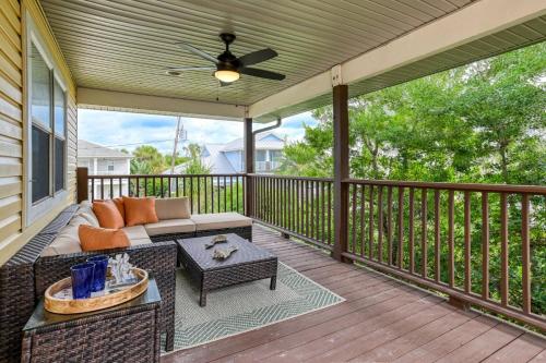a screened in porch with a couch and a table at Golden Mile Beach Retreat in St. Augustine