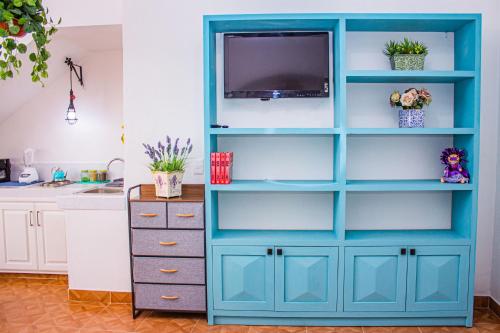 a blue book shelf in a kitchen with a dresser at Casa Cardennal in San Miguel de Allende