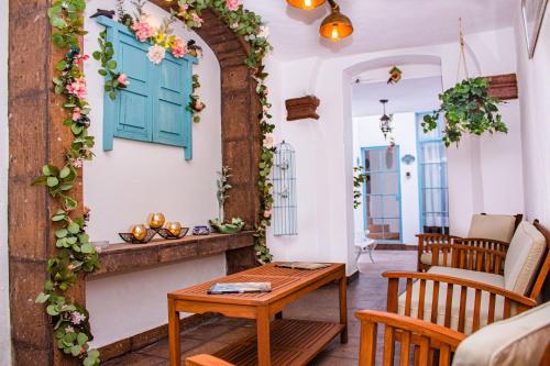 a living room with a table and a window at Casa Cardennal in San Miguel de Allende