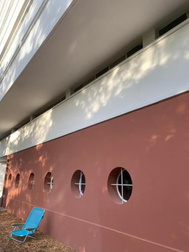 a blue chair sits in front of a red boat at ÉLÉGANT STUDIO DANS BATIMENT HISTORIQUE in Saint-Tropez