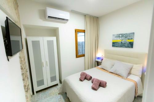 a bedroom with a bed with two towels on it at Casa Estrella y Casa Carmen in Denia