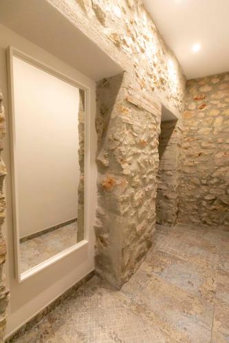 a room with a window and a stone wall at Casa Estrella y Casa Carmen in Denia