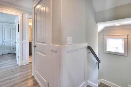 a hallway with a white door in a house at Drift Away in Oak Island