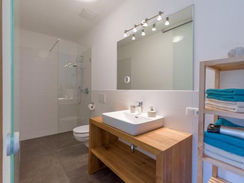 a bathroom with a sink and a shower and a toilet at Villa Grete, St. Johann in Tirol in Sankt Johann in Tirol