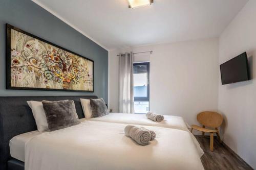 a bedroom with a bed with two towels on it at Apartment Emarin in Banjole