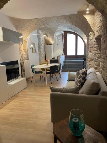 ein Wohnzimmer mit Sofa und Tisch in der Unterkunft Assisi AD Apartaments - Sorella Luna Boutique Home in Assisi