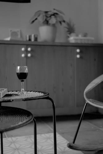 a glass of wine sitting on a table in a kitchen at La Casa del Totumo in Santa Marta