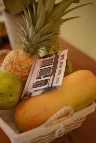 a basket filled with fruit and vegetables on a table at La Casa del Totumo in Santa Marta