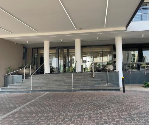 a building with stairs in front of a building at Menlyn Maine Trilogy Hotel in Pretoria