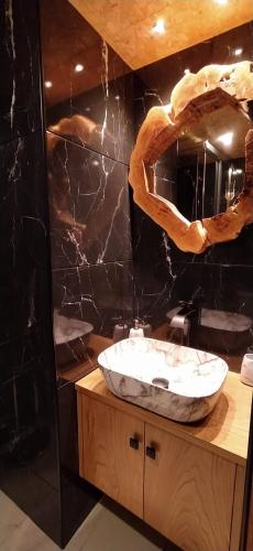 a bathroom with a sink and a large mirror at Casa do Outeiro in Arcos de Valdevez