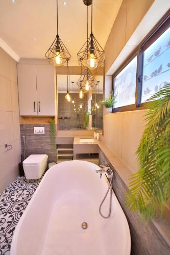 a bathroom with a bath tub and a sink at 18 Storm Sea in Agulhas