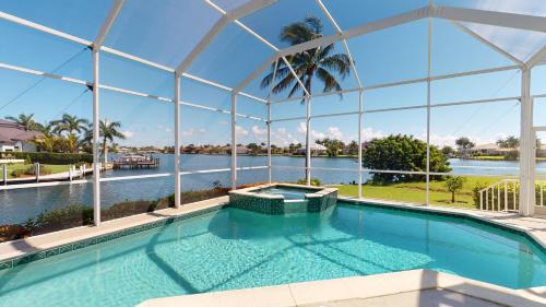 a swimming pool with a view of the water at Luxury Rental Walkable To Beach With Wide Water Views I Pet Friendly in Henry Key