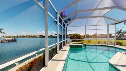 a swimming pool with a view of the water at Luxury Rental Walkable To Beach With Wide Water Views I Pet Friendly in Henry Key