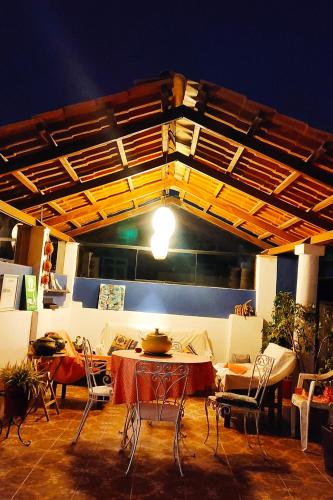 a patio with a table and chairs and a ceiling at Casona Jerusalen in Arequipa