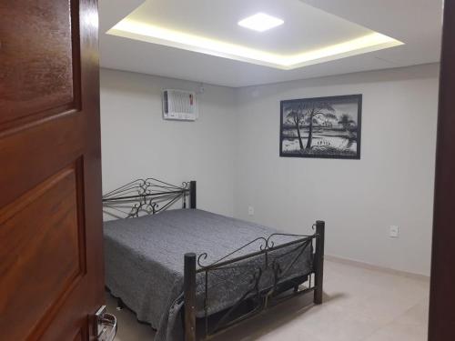 a bedroom with a bed in a white room at Condomínio Sítio Bom - Mangaratiba - Costa Verde in Mangaratiba