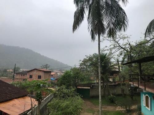 a view of a village with a palm tree at Casa Doce Lar in Paraty