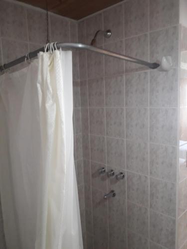 a bathroom with a shower with a shower curtain at Departamentos Paisaje del Beagle in Ushuaia