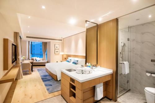 a hotel room with a bed and a bathroom at Argyle Resort Dali Yueyun in Dali