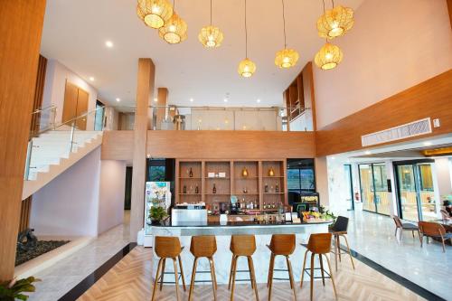 a lobby with a bar with stools at TEVA Valley Resort in Chiang Rai
