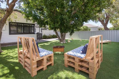 two chairs and a table in a yard at Green House in Busselton