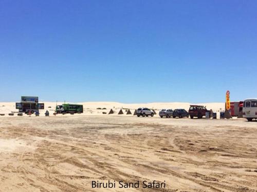 a group of vehicles parked in the desert at Sunset on Birubi pet friendly air con water views WI-FI and outdoor spa in Anna Bay