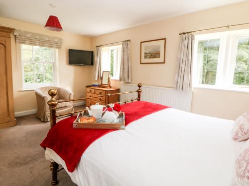Ένα ή περισσότερα κρεβάτια σε δωμάτιο στο Underbank Hall Cottage
