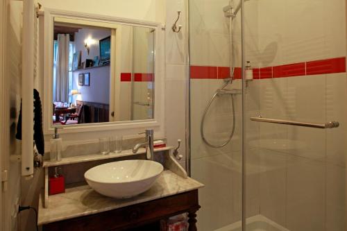 a bathroom with a sink and a glass shower at Les Chambres de Mathilde in Angers