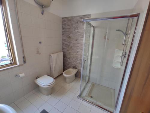 a bathroom with a toilet and a glass shower at B&B SunBeach in San Benedetto del Tronto