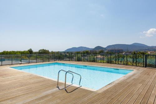 - une piscine sur une terrasse avec des montagnes en arrière-plan dans l'établissement Mandelieu 404 YourHostHelper, à Mandelieu-la-Napoule