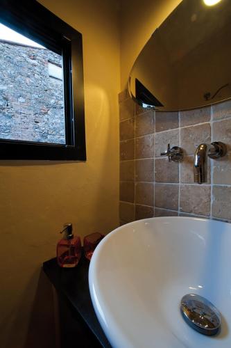 a bathroom with a white sink and a window at Casa Sant Angelo in Sarteano
