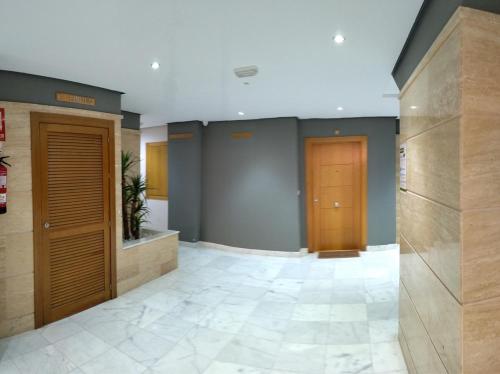 a lobby with two elevators in a building at Alojamiento Apartamento Motril Playa Granada campo golf in Motril