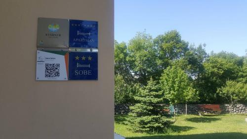 a sign on a wall with a view of a park at Apartments Barbara in Podhum