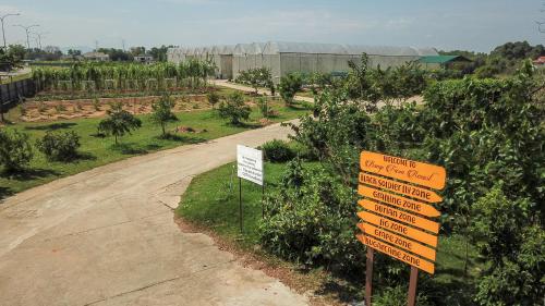 a sign in the middle of a road next to a garden at Bangi Resort Hotel in Bangi