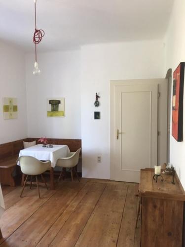 a white room with a table and chairs and a door at Louisenvilla in Bad Gleichenberg
