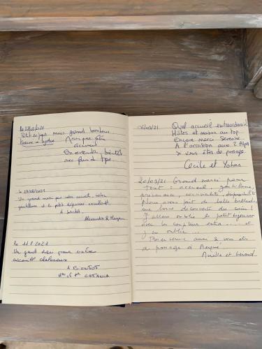 an open notebook with handwriting on it on a shelf at Villa fiora chambre in Martigues