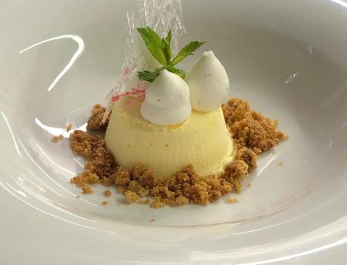 a dessert on a white plate on a table at Active Hotel Monte Giner in Mezzana