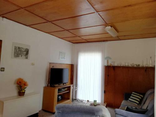 a living room with a couch and a tv at Ferienhaus ruhige Lage _ strandnah in Ueckeritz